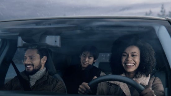 Three passengers riding in a vehicle and smiling | Nissan City of Port Chester in Port Chester NY